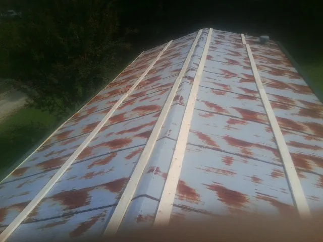 Rusted metal roof panels with new wood purlins before replacement — Storm Damage Roof Repair in Narrowsburg by Roofing Brothers